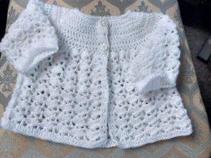 A hand crocheted White baby coat 0-3 months